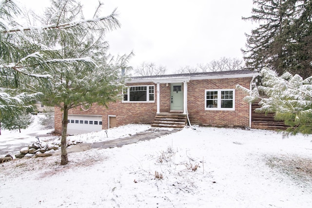 ranch-style house with a garage and brick siding