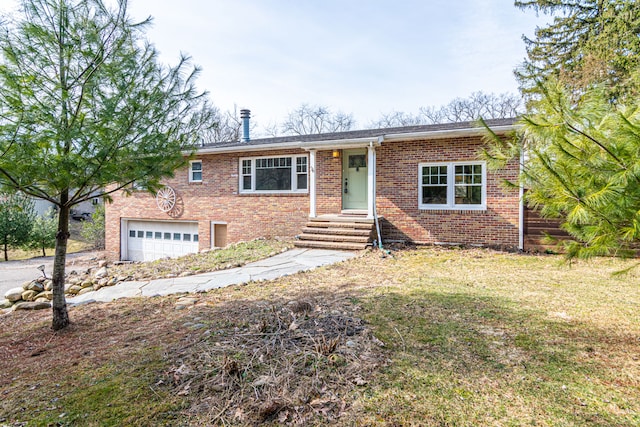 ranch-style house with brick siding, an attached garage, and driveway