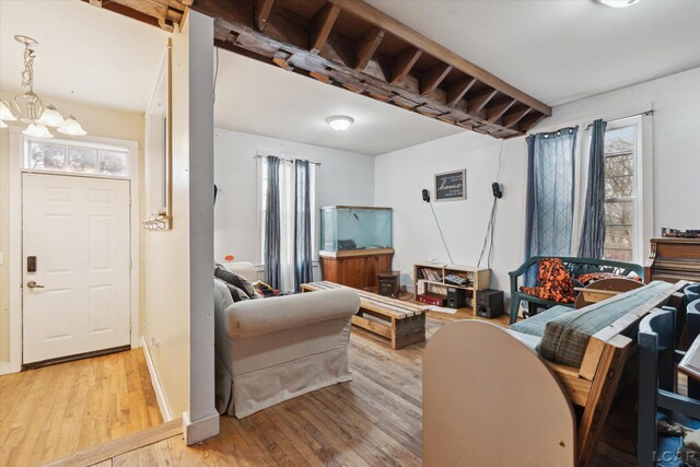 living room with an inviting chandelier and light hardwood / wood-style flooring