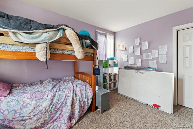 bedroom featuring light colored carpet