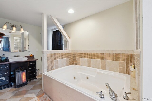 bathroom with vanity, tiled bath, and tile patterned flooring