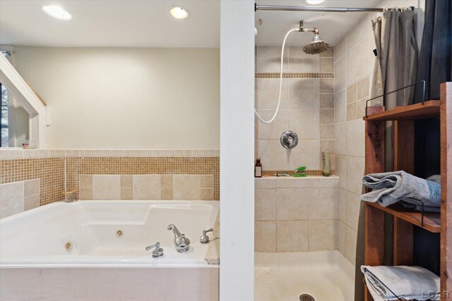 bathroom featuring separate shower and tub