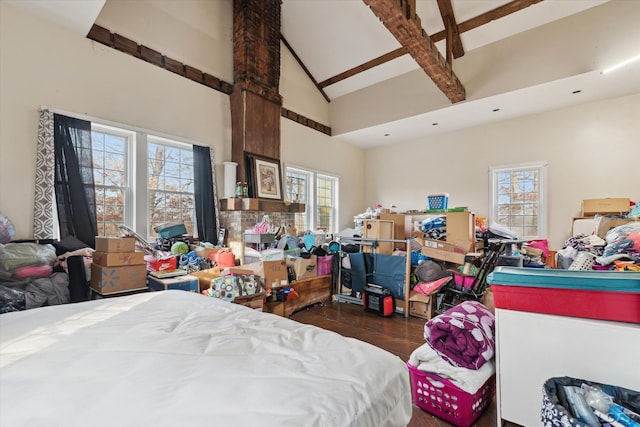 bedroom featuring dark wood-type flooring and high vaulted ceiling