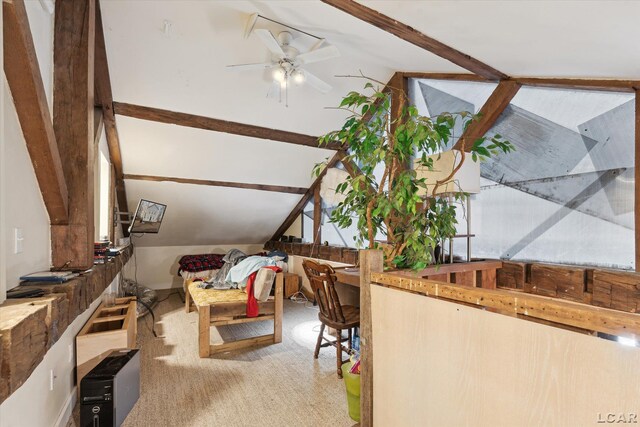 interior space featuring ceiling fan and lofted ceiling with beams