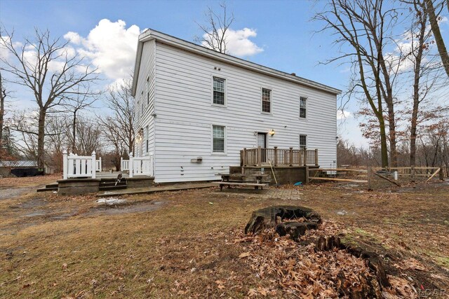 back of house with a deck