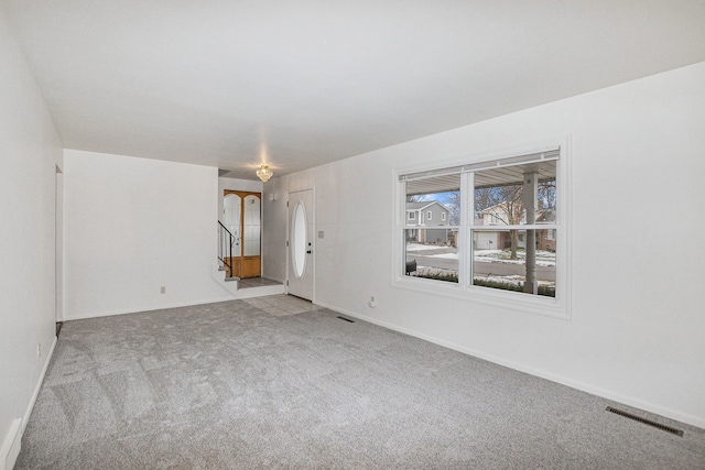 unfurnished room with light colored carpet