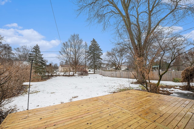 snowy yard with a wooden deck