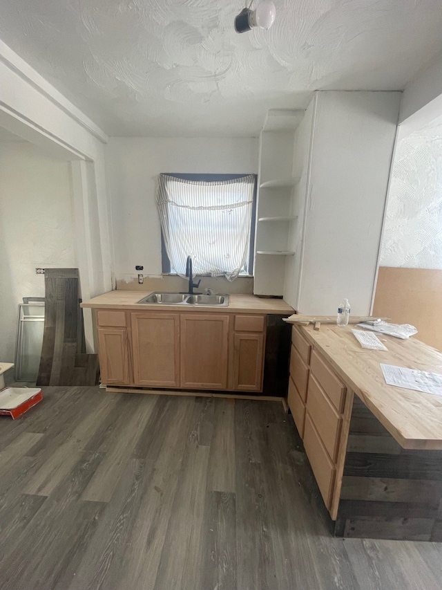 kitchen with dark hardwood / wood-style flooring, sink, wooden counters, and a textured ceiling