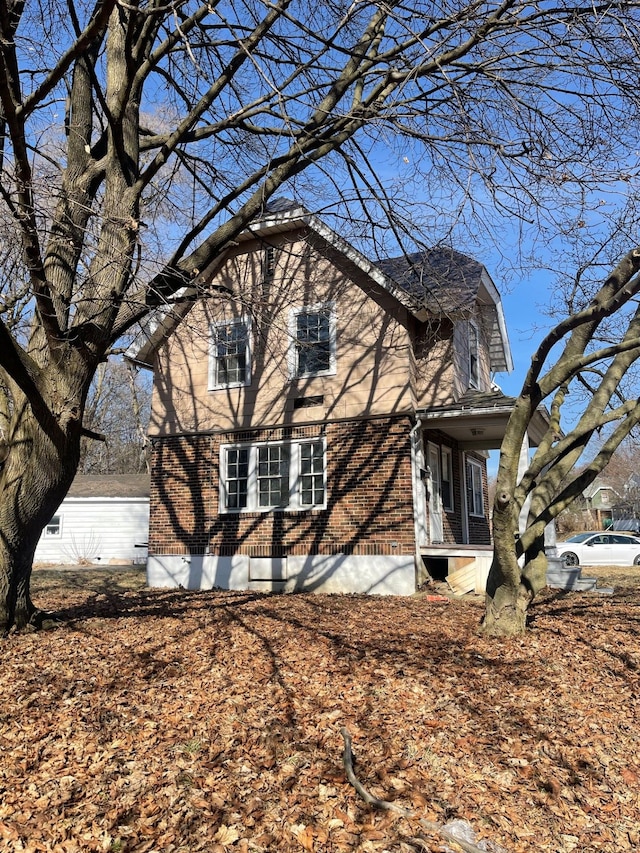 view of side of property with central air condition unit and brick siding