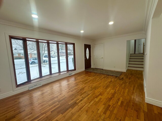 interior space featuring crown molding and hardwood / wood-style floors