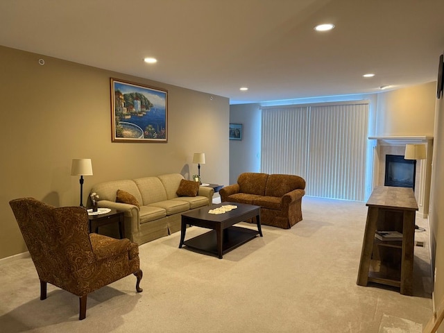 living room with a tiled fireplace and light colored carpet