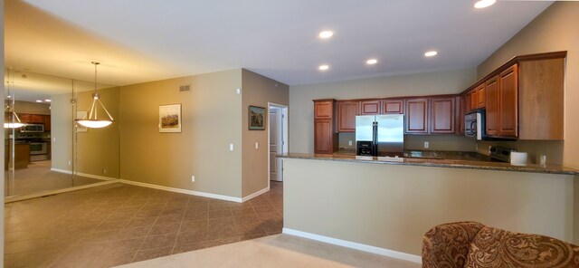 6713 Boulder Pointe Dr, Washington, MI 48094 - kitchen featuring stainless steel appliances, recessed lighting, dark stone countertops, a peninsula, and baseboards
