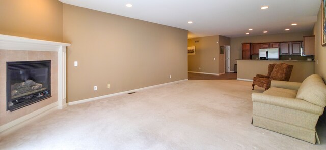 6713 Boulder Pointe Dr, Washington, MI 48094 - living area featuring light carpet, baseboards, recessed lighting, and a tiled fireplace