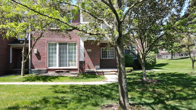 6713 Boulder Pointe Dr, Washington, MI 48094 - view of property hidden behind natural elements featuring brick siding and a front lawn
