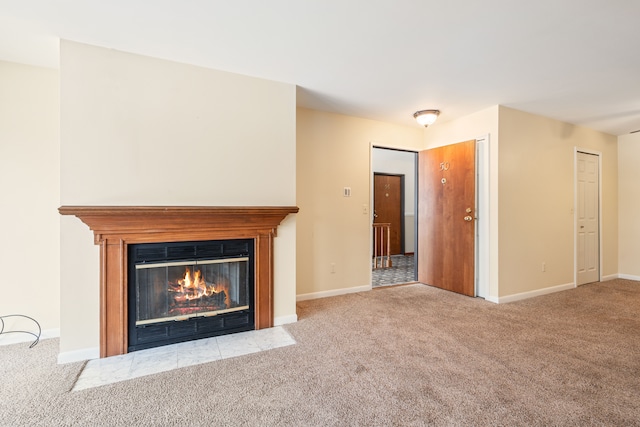 unfurnished living room with a fireplace with flush hearth, baseboards, and carpet