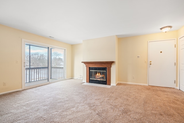 unfurnished living room with a fireplace with flush hearth, baseboards, and carpet flooring