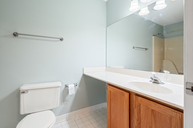 bathroom with walk in shower, vanity, toilet, and tile patterned flooring