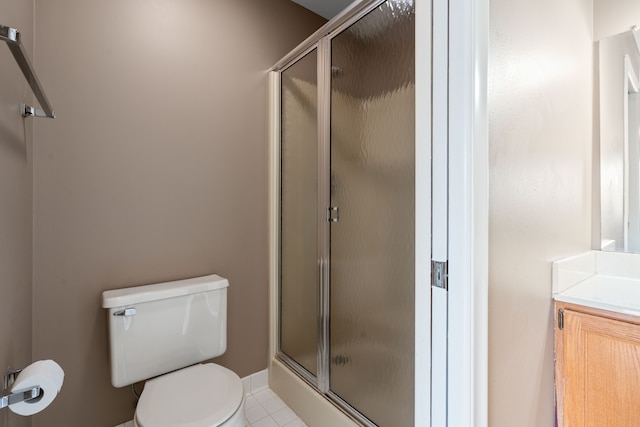 bathroom featuring vanity, tile patterned floors, toilet, and walk in shower