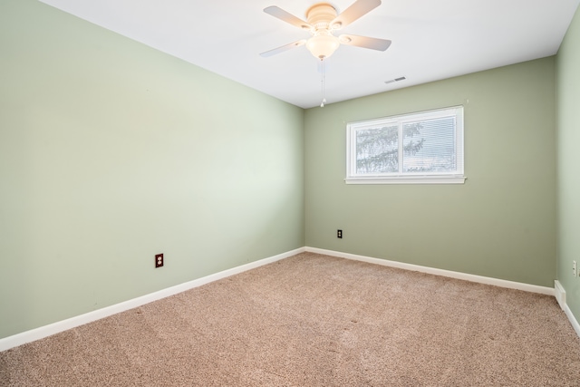 unfurnished room featuring baseboards, visible vents, carpet, and ceiling fan