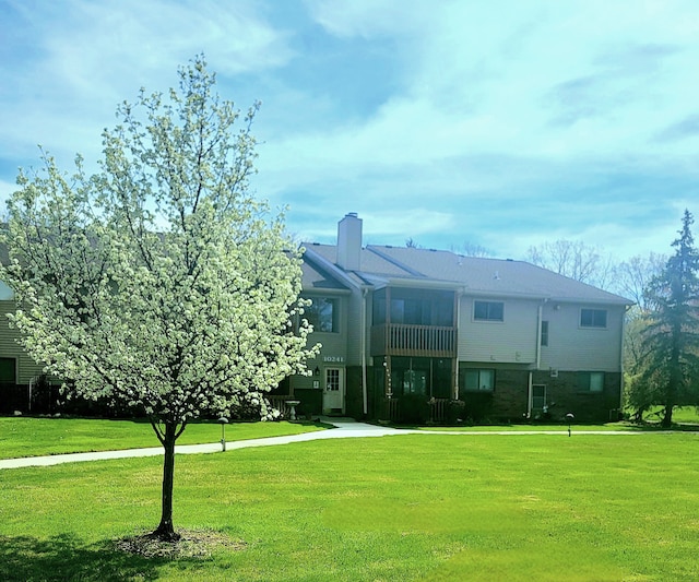exterior space with a lawn and a chimney