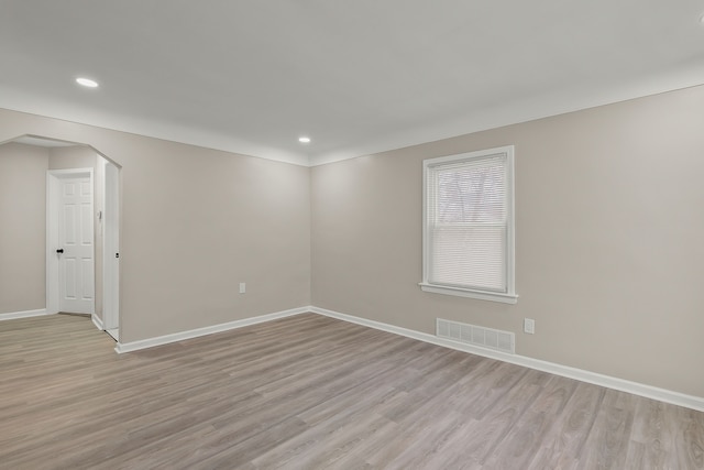 spare room with light hardwood / wood-style flooring