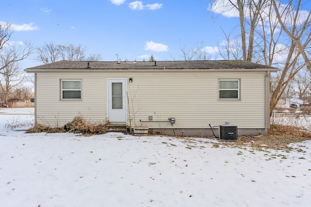 snow covered house with central AC