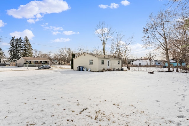 view of snow covered rear of property