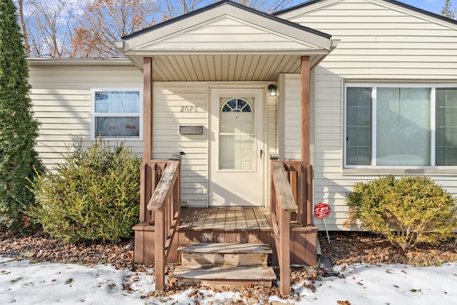 view of snow covered property entrance