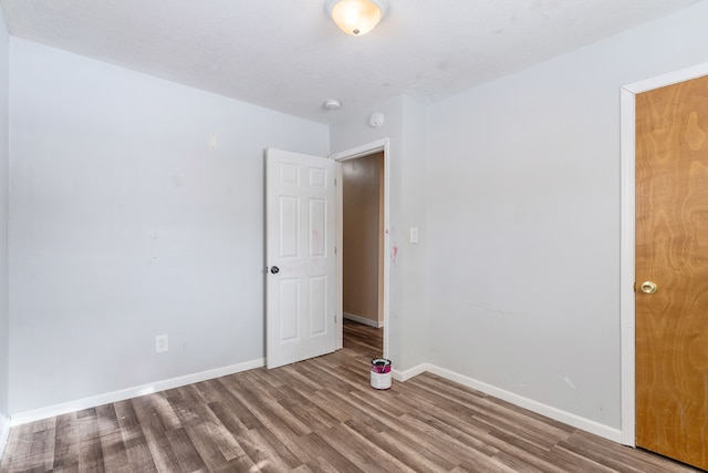 unfurnished room with hardwood / wood-style flooring