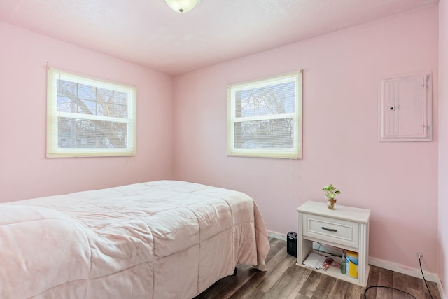 bedroom featuring wood-type flooring and electric panel