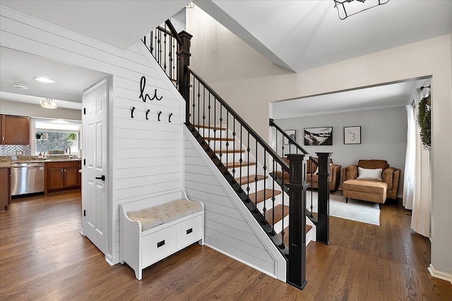 staircase with wood-type flooring and sink