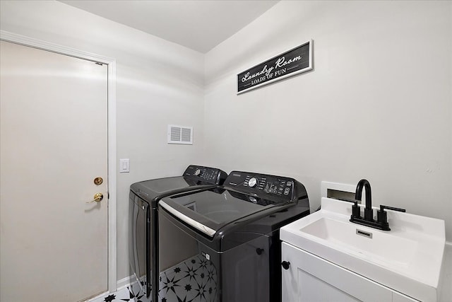 clothes washing area with sink and washer and dryer