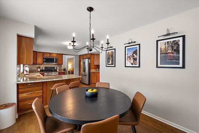 dining area featuring sink and dark hardwood / wood-style floors