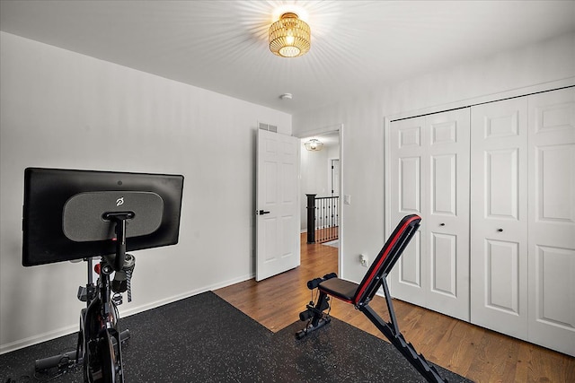 workout room featuring dark wood-type flooring