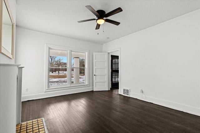 interior space featuring ceiling fan, a textured ceiling, dark wood-type flooring, and ornamental molding