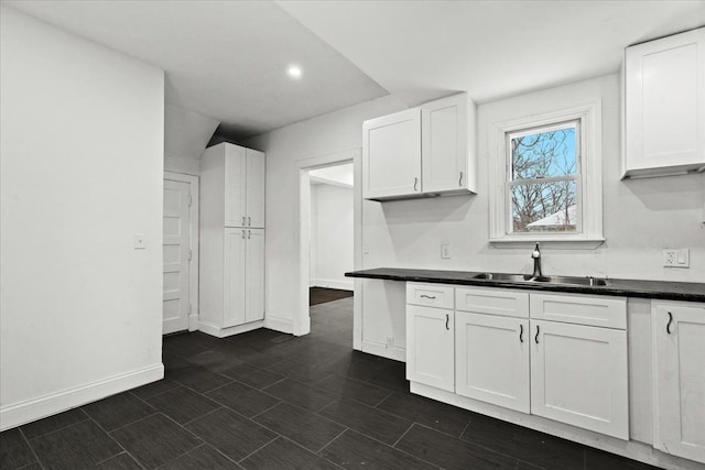 kitchen with white cabinetry and sink