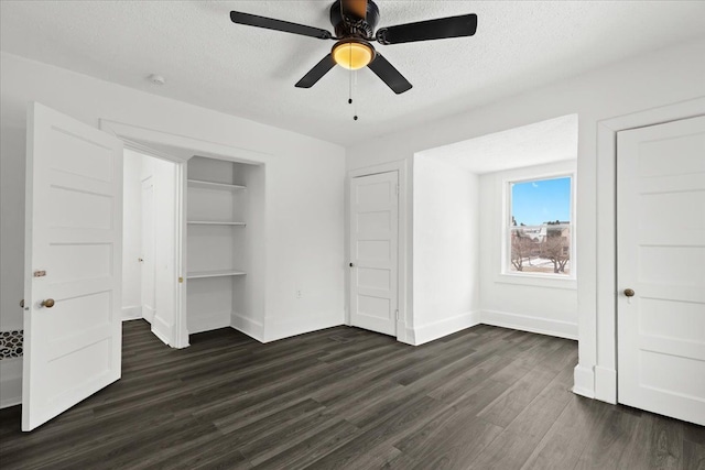 unfurnished bedroom with ceiling fan, a closet, dark hardwood / wood-style flooring, and a textured ceiling