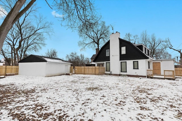 view of snow covered rear of property