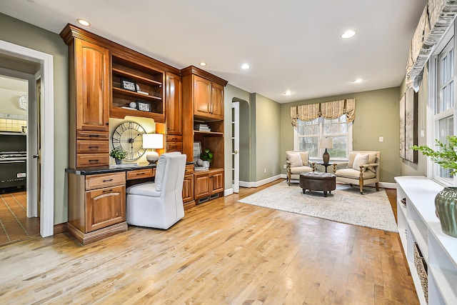 office with built in desk and light wood-type flooring