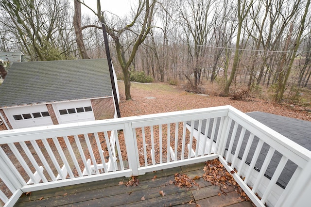 wooden terrace with an outbuilding and a garage