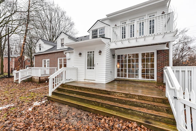 back of house featuring a wooden deck