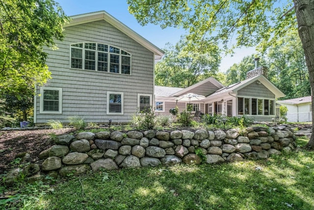 back of property with a sunroom