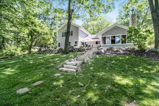 rear view of property featuring a yard