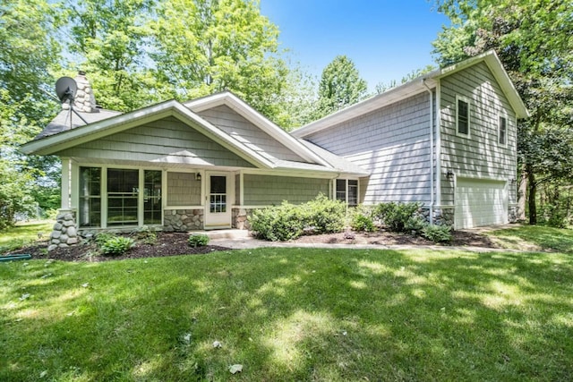 view of front of property with a garage and a front lawn