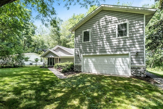 exterior space with a garage and a yard