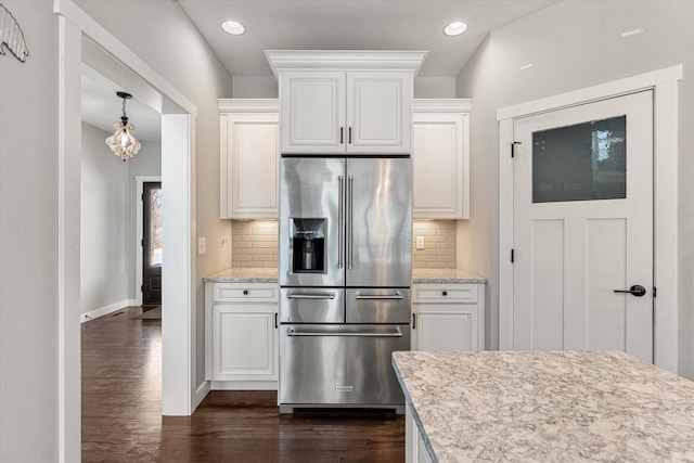 kitchen with white cabinetry, backsplash, dark wood-type flooring, and high end refrigerator