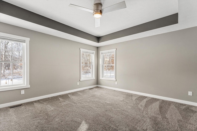 carpeted spare room featuring ceiling fan