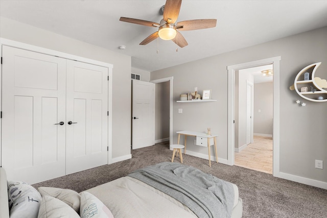 carpeted bedroom featuring ceiling fan and a closet