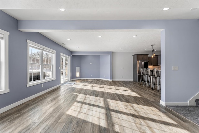 unfurnished living room with wood-type flooring