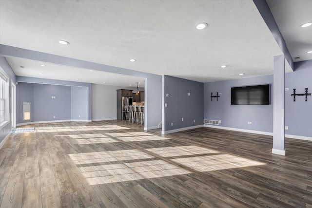 unfurnished living room with hardwood / wood-style floors